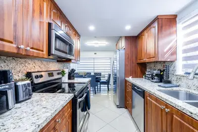 a kitchen with wooden cabinets and a counter top at West Kendall Retreat Everglades Miccosukee in Hammocks