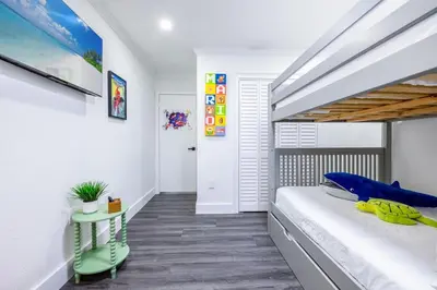 a bedroom with a large bed with a wooden headboard at West Kendall Retreat Everglades Miccosukee in Hammocks