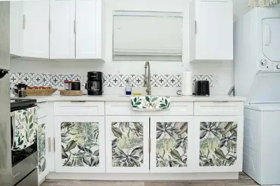 a kitchen with white cabinets and a sink at Mar & Luna Family retreat in Miami