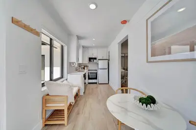 a living room with a table and a kitchen at Waterfront Unit #1 20 Min Walk to Beach and Shops in Fort Lauderdale