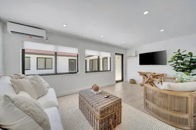 a living room with a couch and a table at Waterfront Unit #3 20 Min Walk to Beach and Shops in Fort Lauderdale