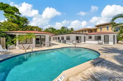 a swimming pool in front of a house at Waterfront Unit #3 20 Min Walk to Beach and Shops in Fort Lauderdale