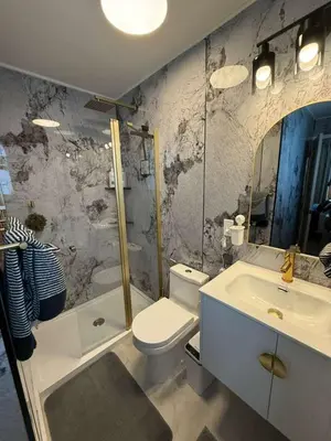a bathroom with a toilet and a tub and a sink at Trio in Miami