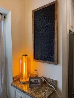a table with a blender and a picture on a wall at Trio in Miami