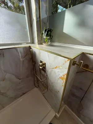 a bathroom with a counter and a window and a sink at Trio in Miami