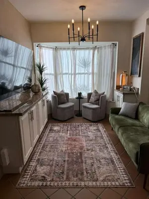 a living room with two couches and a chandelier at Trio in Miami