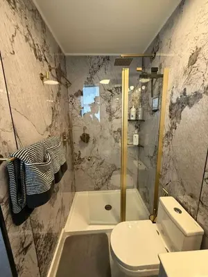 a bathroom with a shower and a toilet and a tub at Trio in Miami
