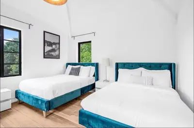 two beds in a room with white walls at Sunny Miami Escape in Prime Location
