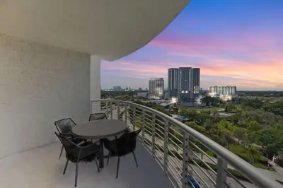 a balcony with a table and chairs and a city skyline at 2BR Condos Circ Hotel by Hosteeva in Hollywood
