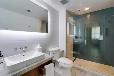 a bathroom with a toilet and a sink and a shower at 2BR Condos Circ Hotel by Hosteeva in Hollywood