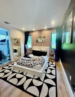 a bedroom with a large bed and a black and white rug at Luxury Gem in Fort Lauderdale