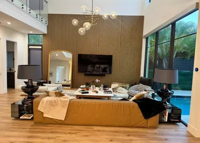 a living room with a couch and a mirror at Luxury Gem in Fort Lauderdale