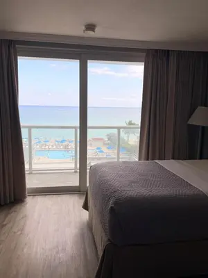 a bedroom with a bed and a view of the ocean at Direct Ocean View Condo,Balcony kitchen pool gym sauna valet parking direct beach access for perfect vacation in Sunny Isles Miami in Sunny Isles Beach