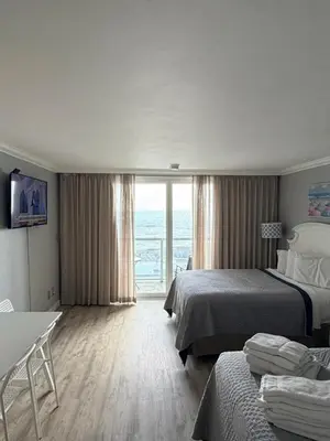 a hotel room with two beds and a view of the ocean at Direct Ocean View Condo,Balcony kitchen pool gym sauna valet parking direct beach access for perfect vacation in Sunny Isles Miami in Sunny Isles Beach