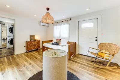 a bedroom with a bed and a table and a chair at 5 Mi to Las Olas Beach! Bright Home with Fenced Yard in Fort Lauderdale