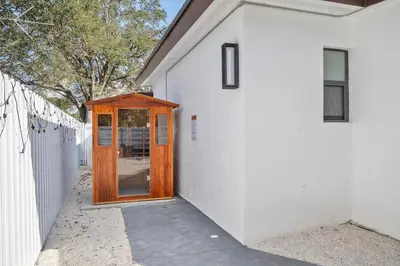 a wooden door on the side of a white building at Miami Hotel Home in North Miami