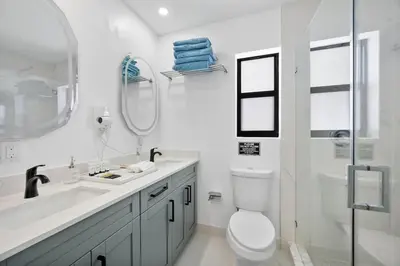 a bathroom with a toilet and a sink and a shower at Miami Hotel Home in North Miami