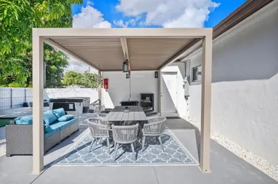 an outdoor patio with a table and chairs at Miami Hotel Home in North Miami