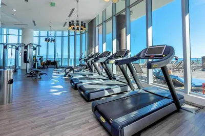 a gym with a row of treadmills at Oceanfront dream W pool & beach access in Hollywood