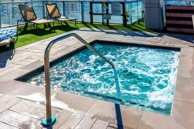 a hot tub with a hand rail in a building at Oceanfront dream W pool & beach access in Hollywood