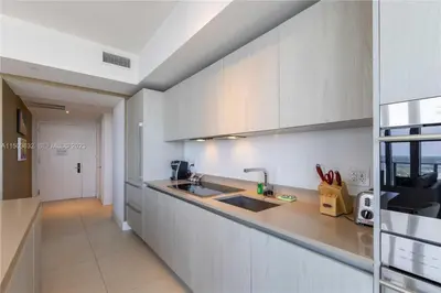 a kitchen with a sink and a counter top at Oceanfront dream W pool & beach access in Hollywood