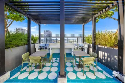 a patio with a table and chairs on a roof at Cozy Ensuite 1BR Apartment in DTW Miami in Miami
