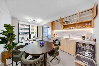 a kitchen and dining room with a table and chairs at Cozy Ensuite 1BR Apartment in DTW Miami in Miami
