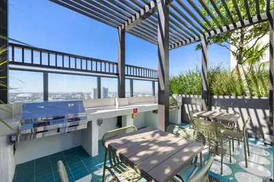 a patio with a table and chairs on a balcony at Central Downtown Condo with Pool & Gym in Miami