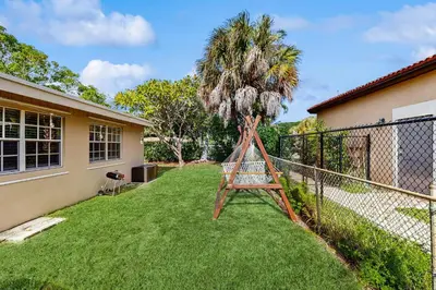 a palm tree in the yard of a house at The Palms in Fort Lauderdale