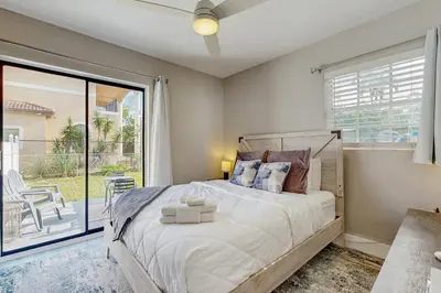 a bedroom with a bed and a large window at The Palms in Fort Lauderdale