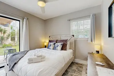 a bedroom with a bed and a large window at The Palms A in Fort Lauderdale