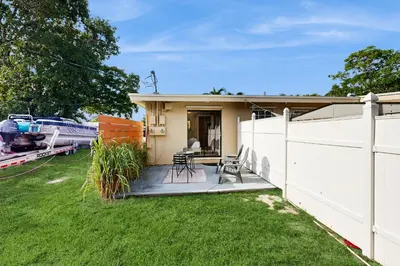 a house with a white fence and a yard at The Palms A in Fort Lauderdale