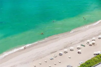 an overhead view of a beach with umbrellas and the ocean at Lux Beachfront Retreat at Hyde Resort w OceanView in Hollywood