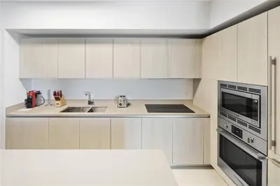 a kitchen with a sink and a microwave at Lux Beachfront Retreat at Hyde Resort w OceanView in Hollywood