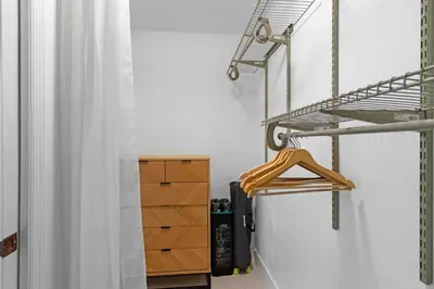 a closet with a wooden dresser and a shelf at 7BD Downtown Oasis - Pool - 10 Mins to South Beach in Miami