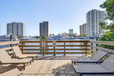 a deck with chairs and a view of a harbor at Resort Condo By Aventura Mall! Gated Community in Aventura