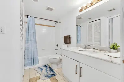 a white bathroom with a toilet and a sink at Upscale4 Brickell Retreat with Bay n City Views in Miami