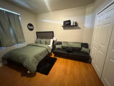 a bedroom with a bed and a couch at The B Shared Resident in Miramar