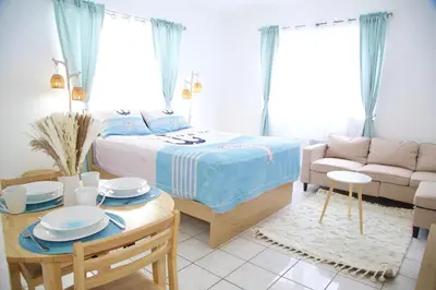 a bedroom with a bed and a table and a couch at Cozy3 Miami Beach Getaway Quick Walk to the Ocean in Miami Beach