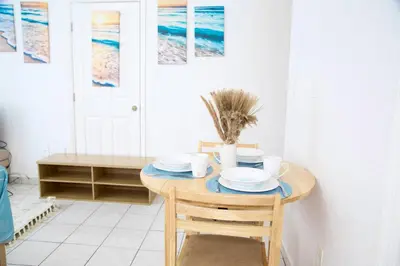 a dining room with a table with plates on it at Cozy3 Miami Beach Getaway Quick Walk to the Ocean in Miami Beach