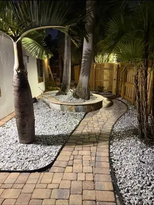 a courtyard with palm trees and a stone walkway at Pool House in Fort Lauderdale in Fort Lauderdale