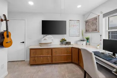 a room with a desk with a computer and a guitar at Plantation Pool Home with Hot Tub Sleeps 10 in Plantation