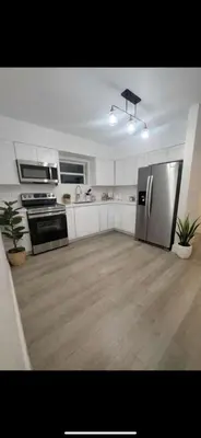 a kitchen with a stainless steel refrigerator and appliances at Santorini Hollywood in Hollywood