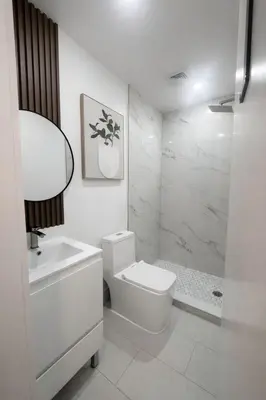 a white bathroom with a toilet and a shower at Santorini Hollywood in Hollywood