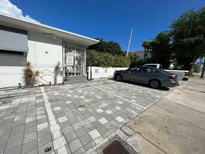 a car parked in a parking lot in front of a garage at Miami Studio a Few Steps to the Beach in Miami