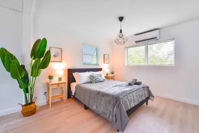 a bedroom with a bed and a potted plant at Miami Studio a Few Steps to the Beach in Miami