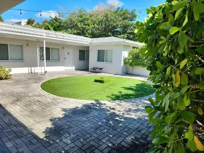 a house with a lawn in front of it at Miami Studio a Few Steps to the Beach in Miami