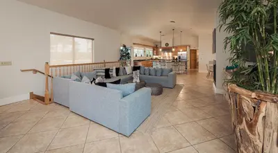 a living room with two blue couches and a kitchen at Oceanfront Luxury Villa 5Bedroom and 4Bath Beach Access in Hollywood