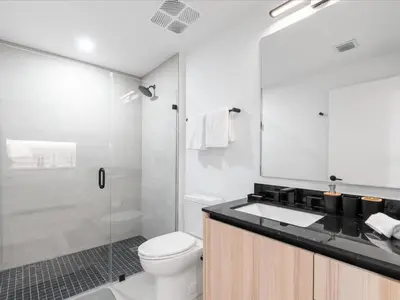 a bathroom with a toilet and a sink and a shower at Stylish Studio in Downtown Location in Miami