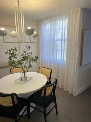 a dining room with a white table and chairs at The Yacht Club at Aventura Miami 4405 in Aventura